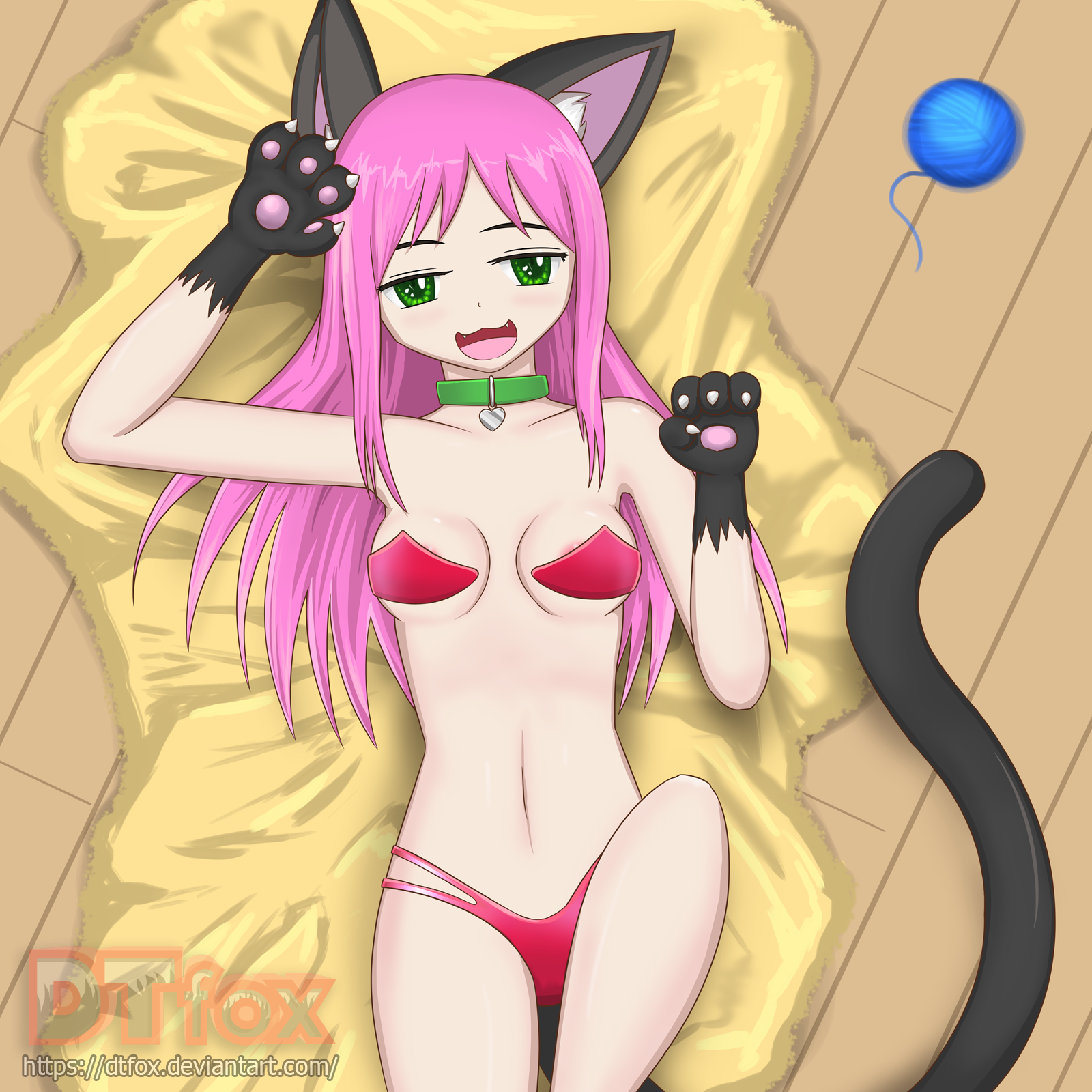 A sexy cat girl lays on the floor suggestively next to a ball of yarn
